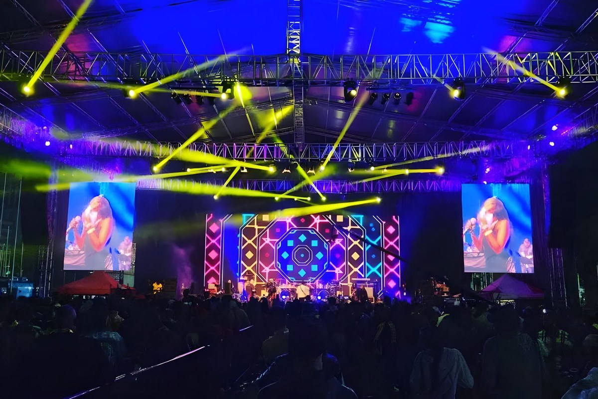 MoSound lighting rig with moving-head beams and LED screens over a festival stage