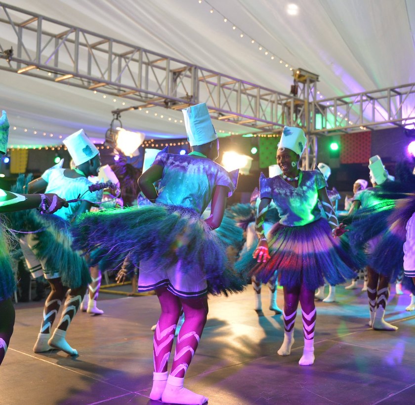 Performers in the GES 2015 tented venue under the overhead truss and lighting